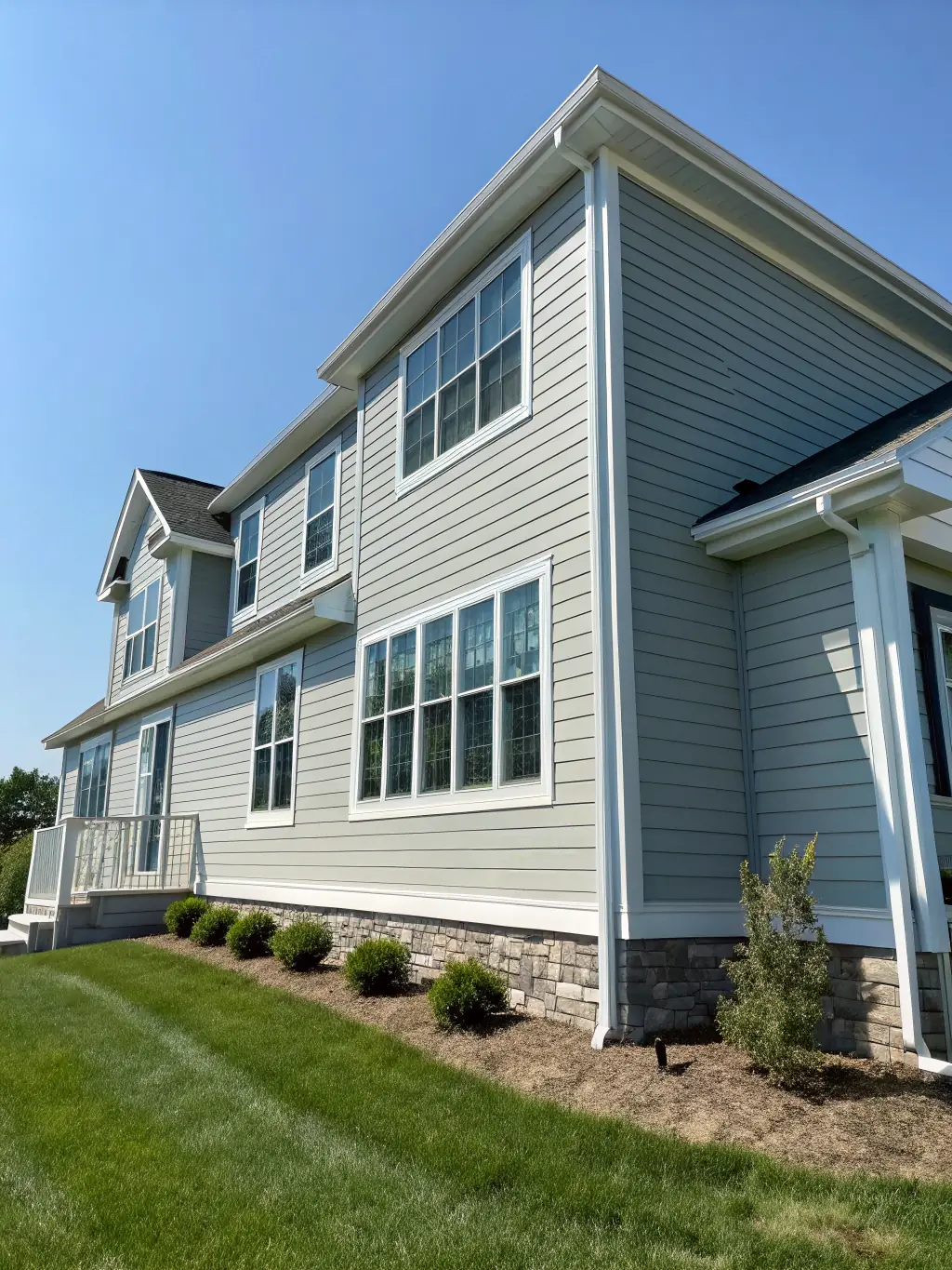 A well-maintained house exterior with newly painted siding and trim, demonstrating ProCoat Painting & Decor.'s commitment to enhancing curb appeal and protection.